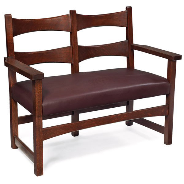 Limbert settee, two-seat form: Limbert settee, two-seat form with two trumpeted slats at back above a recovered leather seat and arched rail, refinished, branded signature, 44"w x 22.5"d x 36"h, very good condition