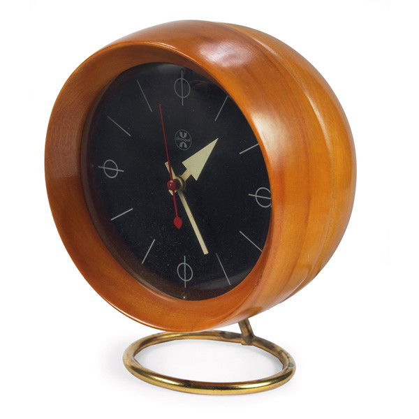 George Nelson table clock, round birch wood: George Nelson table clock, by Howard Miller, round birch wood case with curved glass over a brass-plated ring base, original finish, Howard Miller label, 5.5"w x 4.5"d x 6.5"h, excellent condition