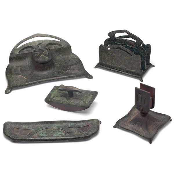 Bradley & Hubbard desk set, bronze metal, Teco bow: Bradley & Hubbard desk set, inkwell, letter rack, pen tray, rocker blotter and match holder, bronzed metal with stylized designs and a mottled green patina, most marked, #3182, 3183, 3185, largest is: