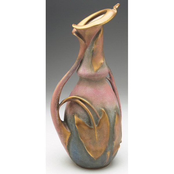 Amphora handled vessel, Eduard Stellmacher: Amphora handled vessel, probably designed by Eduard Stellmacher, carved and applied calla lily and leaves, covered in colorful glazes, marked, #495, 6"w x 14"h, restoration to spout