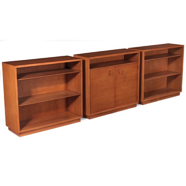 Gilbert Rohde bookcases, three-piece set, by Herma: Gilbert Rohde bookcases, three-piece set, by Herman Miller, one with two doors under an open compartment, two with fixed shelves, refinished, each signed with a Gilbert Rohde/Herman Miller foil label,