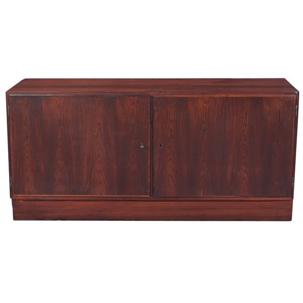 Danish cabinet, rosewood, two doors: Danish cabinet, rosewood, two locking doors, platform base, interior consists of two drawers and two shelves, one key, original finish, stamped with maker's mark and "Made in Denmark", 54.5"w x 17"d x