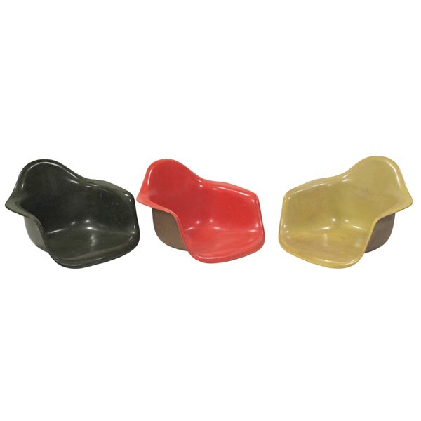 Charles & Ray Eames shells, three: Charles & Ray Eames shells, three, by Herman Miller, no bases, molded fiberglass, one dark green, one orange, one yellow, small puncture to seat of orange shell and one missing shock mount, original f