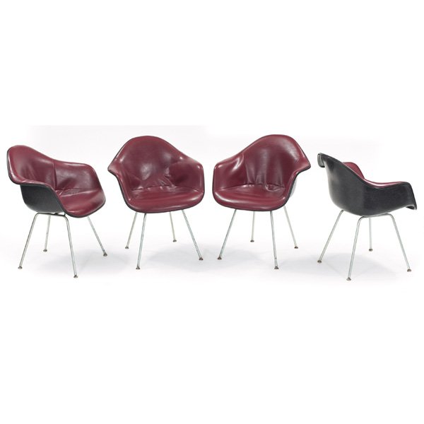 Charles and Ray Eames shell chairs, four, 1971: Charles and Ray Eames shell chairs, four, by Herman Miller, black fiberglass shells with the original burgundy vinyl seats, all feet intact, original finish, signed with Herman Miller labels, dated 19