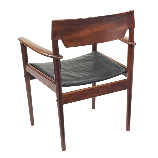 Grete Jalk armchair, rosewood, Poul Jeppesen: Grete Jalk armchair, by Poul Jeppesen, rosewood, carved arms, sculptural backrest, rear legs pass through holes in the armrests, original black leather upholstery, original finish, signed with Poul Je