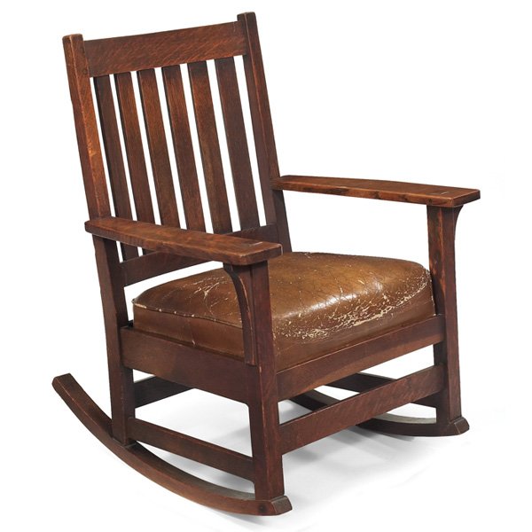 L & JG Stickley rocker: L & JG Stickley rocker, #817, six vertical slats at back above a worn original leather cushion and corbel supports at sides, signed "The Work of..." original finish, 27"w x 30"d x 35"h, very good cond