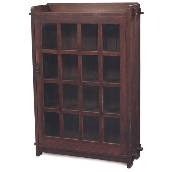 L & JG Stickley bookcase #643 single-door form: L & JG Stickley bookcase, #643, single-door form with sixteen panes of glass and original hardware, slab sides supported by double key and tenon construction, signed with Handcraft decal, original fin