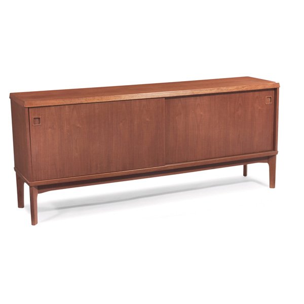 E. Jakobsen sideboard Denmark: E. Jakobsen sideboard, Denmark, teak, two sliding doors, recessed square pulls, interior contains two small drawers and two shelves, original finish, signed with branded mark and paper label, 71"w x 1