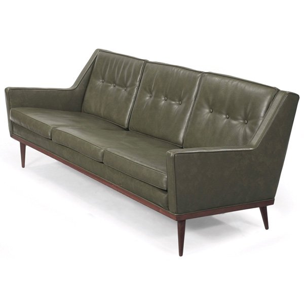 Milo Baughman sofa James Articulate Seating: Milo Baughman sofa, by James Articulate Seating, 1950s, tufted backrest cushions, flared wood legs, original dark green vinyl upholstery, original finish, signed with Milo Baughman/James label, 70.5"w