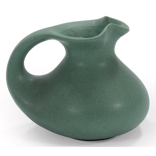 Teco cream pitcher #56 green matte glaze: Teco cream pitcher, shape #56, designed by W.D. Gates, pinched mouth over a bulbous body in a green matte glaze, signed, 5.5"w 4"h
