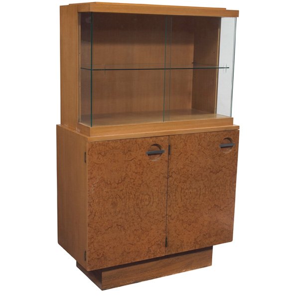 Gilbert Rohde Formal Dining Group china cabinet "3725": Gilbert Rohde Formal Dining Group china cabinet, by Herman Miller, 1940s, Maidou burl and mahogany, lower portion with two doors with round cutouts with horizontal nickel bar, one adjustable wood shel