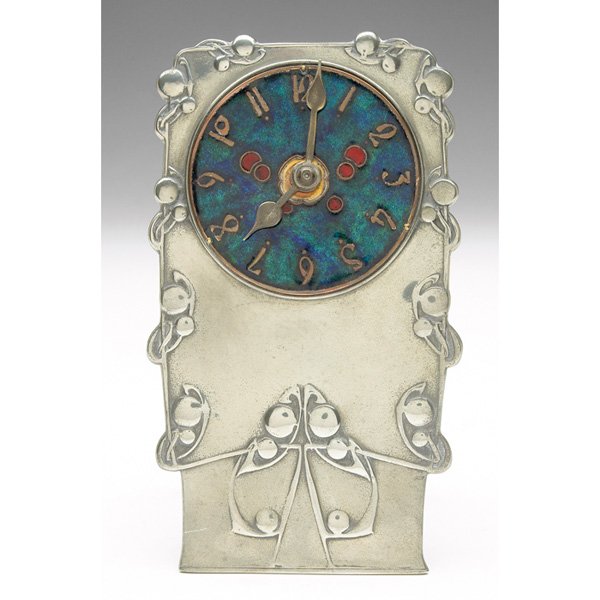 Liberty & Co. clock Archibald Knox Tudric pewter: Liberty & Co. clock, designed by Archibald Knox, c. 1903, Tudric pewter with repousse designs, colorfully enameled face with hand-drawn numbers, applied and curved stand, marked, #0608, 3"w x 5.5"h