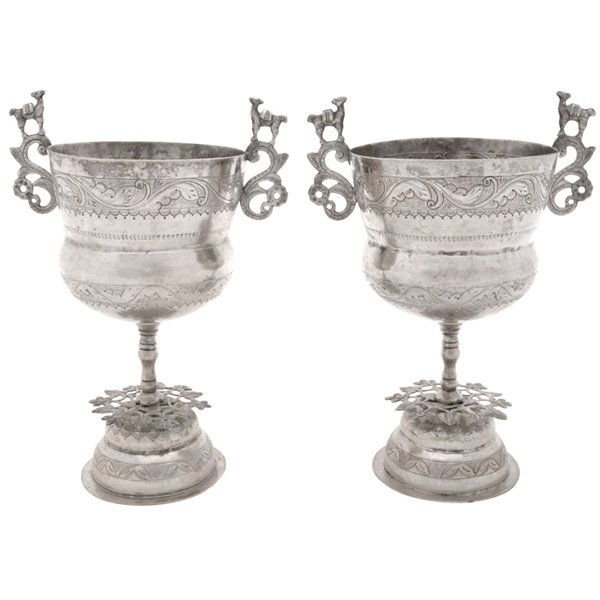 Peruvian silver chalices: Peruvian silver chalices, pair, applied scrolling handles surmounted with llamas, foliate chased banded decoration, turned standard, pierced flowering vine accent, stepped domed foot, =35.48 ozt., tal