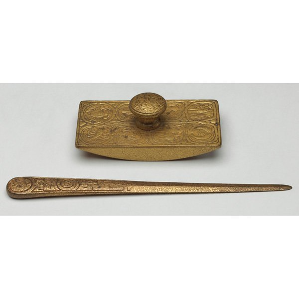 Tiffany Studios letter opener: Tiffany Studios letter opener, #1095, 11"l; with a rocker blotter, #990, 5.5"w x 2"h, both bronze in the Zodiac pattern, both with original gold dore patinas, both signed Tiffany Studios, New York, 5"