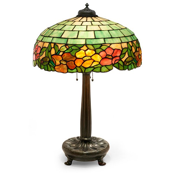 Wilkinson table lamp: Wilkinson table lamp, bronzed metal base supporting a leaded glass shade with a colorful floral design, unsigned, base numbered, overall: 19"w x 27"h, similar shades are pictured in Mosaic Shades, by 