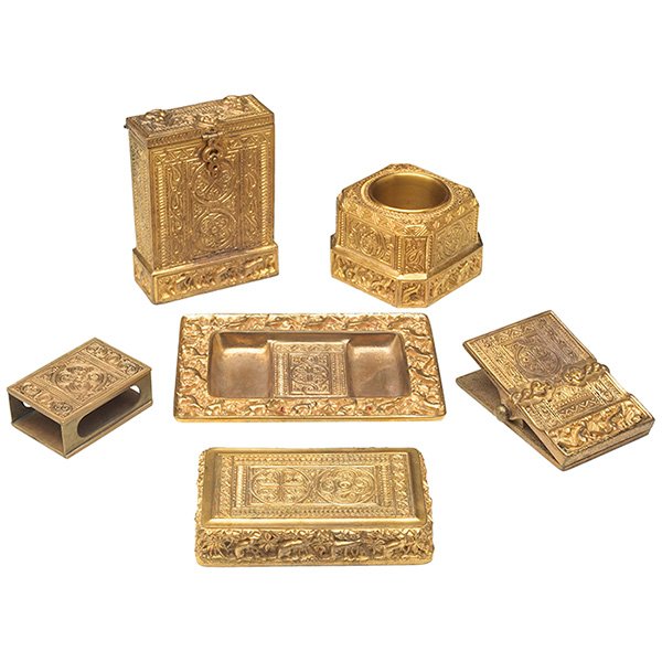 Tiffany Studios, Venetian desk items: Tiffany Studios, Venetian desk items: matchbox holder, #1856, card case, #1692, ash receiver, #1689, paperweight, #1647, pen brush holder, #1686, clip, #1693, New York, NY, bronze, gold dore patina, a