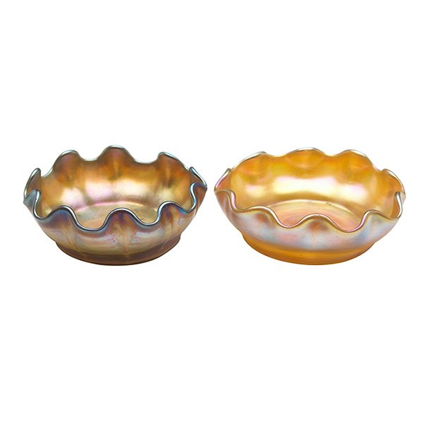 Louis Comfort Tiffany (1848-1933), salt cellars, two,: Louis Comfort Tiffany (1848-1933), salt cellars, two, New York, NY, Favrile glass, signed, overall iridescence, 3"dia x 1"h