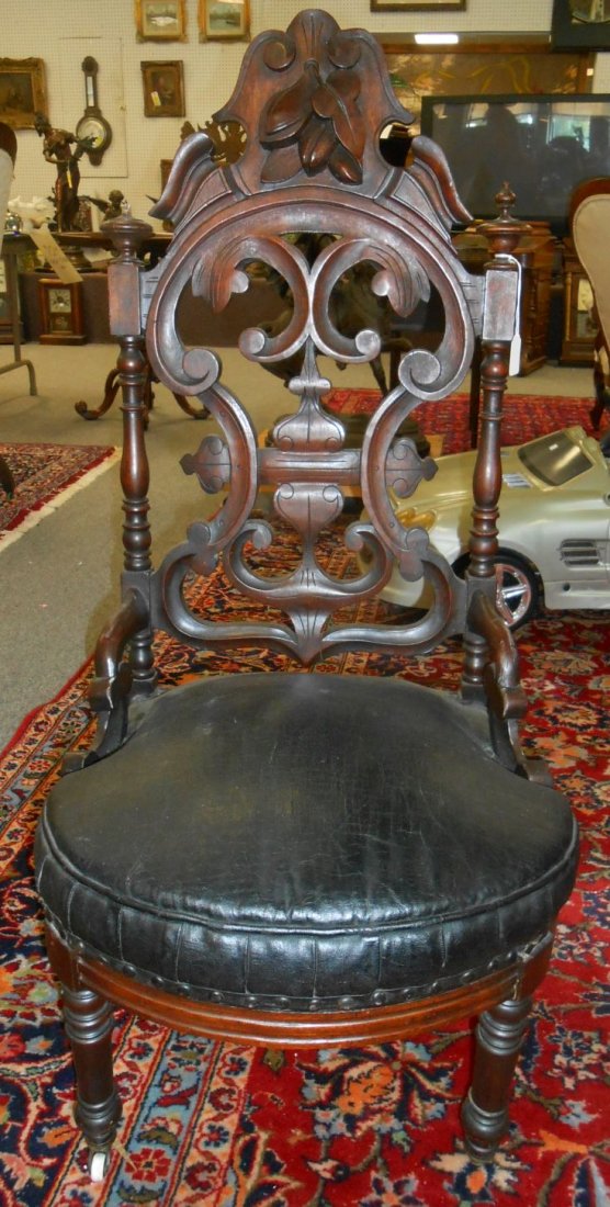 Antique Carved Walnut Slipper Chair: Antique Carved Walnut Slipper Chair. Nicely carved. Circa 1870. Measures 41" tall. Condition is good with some wear and scratches typical from age. Also, Finial is broken off on one side.