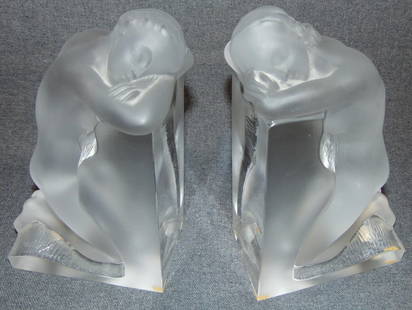 Lalique Frosted & Clear Crystal "Reverie" Bookends: Lalique French Crystal Frosted & Clear Reverie Bookends. 2 Beautiful Kneeling Nudes. Each measures 8-3/4" tall. Condition is Mint. No Damage. Starting Bid $50. Auction Estimate $1200 - $1400.