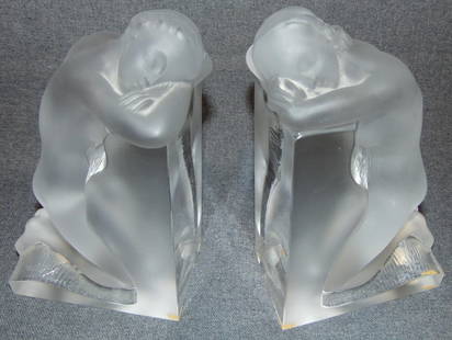 Lalique Frosted & Clear Crystal "Reverie" Bookends: Lalique French Crystal Frosted & Clear Reverie Bookends. 2 Beautiful Kneeling Nudes. Each measures 8-3/4" tall. Condition is Mint. No Damage. Starting Bid $50. Auction Estimate $1200 - $1400.