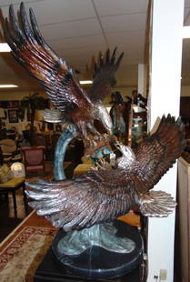 Large Bronze Eagles Dueling Sculpture on Marble: Large and Fabulous Bronze Double Eagles Sculpture on a Black Marble Base. 2 Eagles Dueling in Flight. Sculpture is Artist Signed. Measures 42" tall x 34" wide. Round Marble Base is 18" in Diameter. Hi