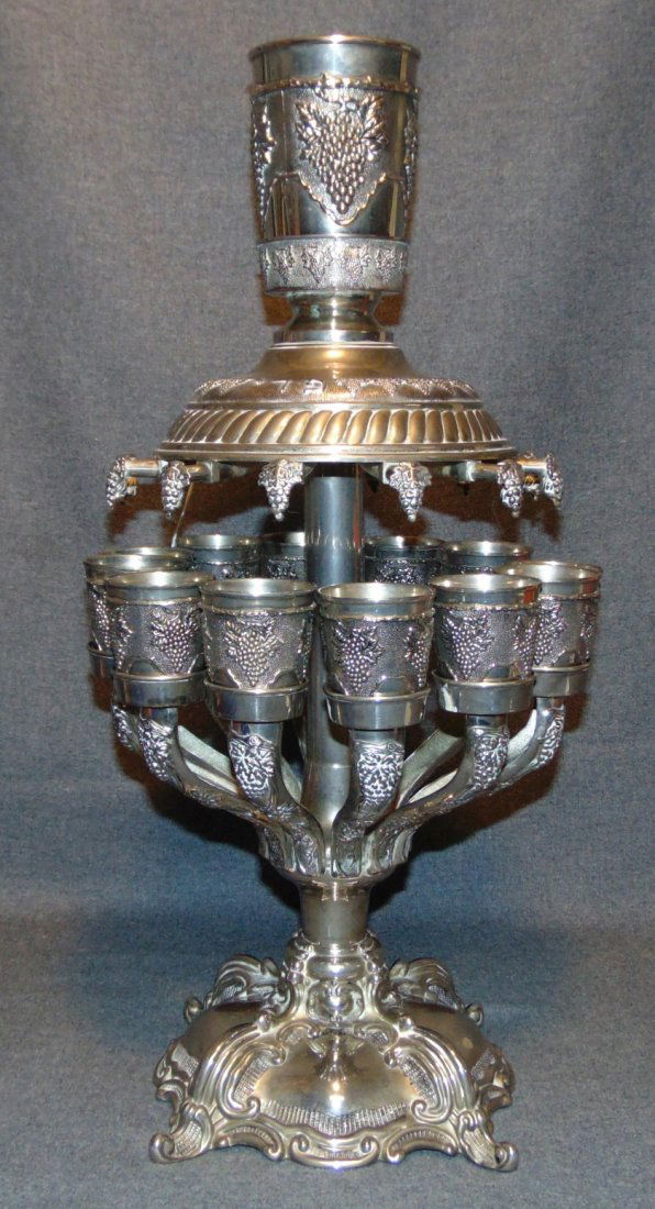 Silver Plated Jerusalem Kiddush Cups Set Wine Fountain: Silver Plated Jerusalem Kiddush Cups Set Wine Fountain. Measures 22" tall x 11" wide. Overall condition is good with minor wear typical from age. Starting Bid $50. Auction Estimate $180 - $250.