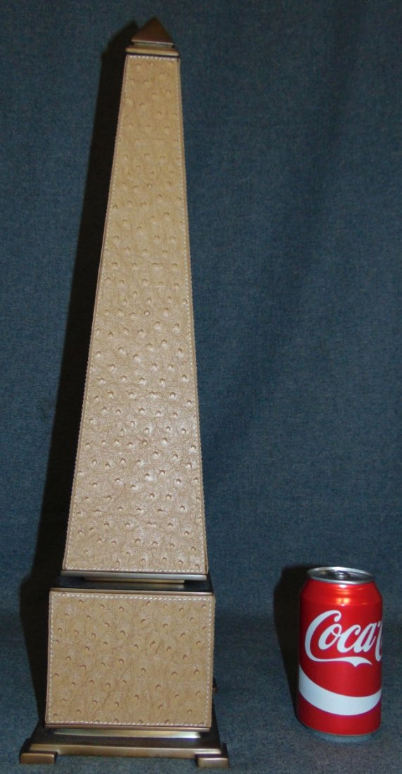 Ostrich Leather & Brass Hollywood Regency Obelisk: Decorative Ostrich Leather & Brass "Hollywood Regency Style" Obelisk. Measures 23" tall. Condition is very good. No damage. Starting Bid $50.