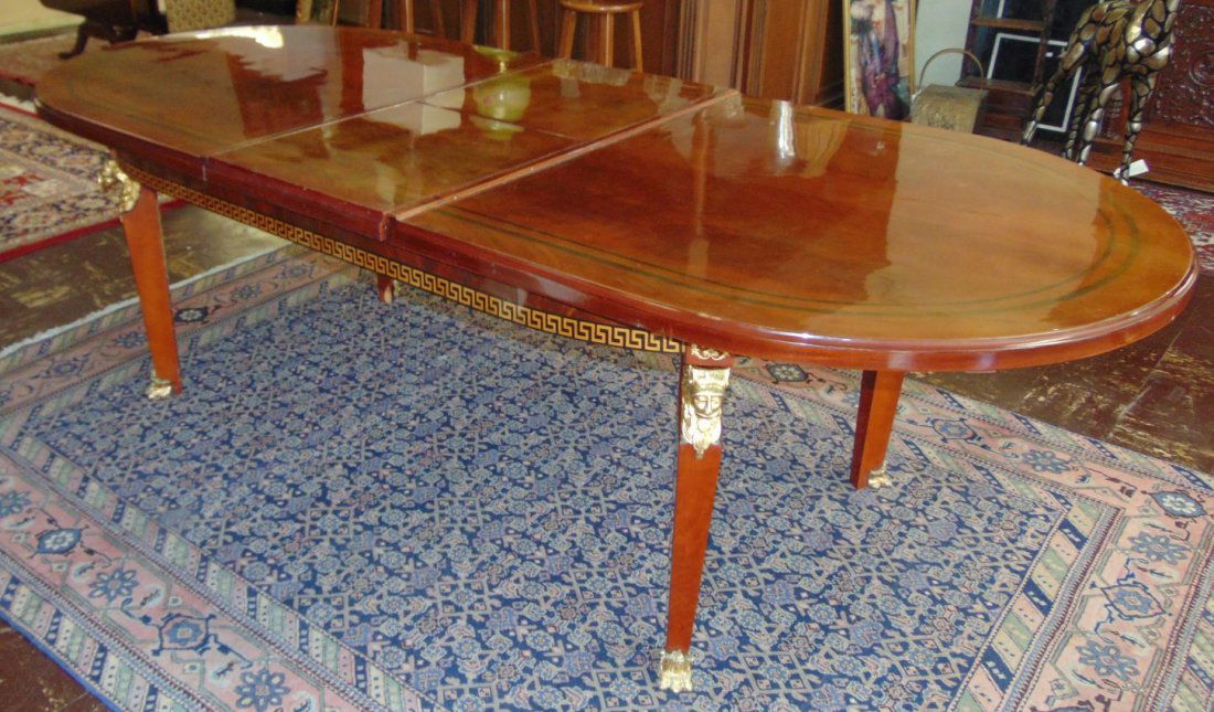 Versace Style Oval Dining Table: Versace Style Oval Dining Table with Bronze Mounts & Feet. Like New Condition. Beautiful Greek Key Design. Butterfly leaves recess inside when not in use. Measures 32" tall x 88" wide x 46" deep befor
