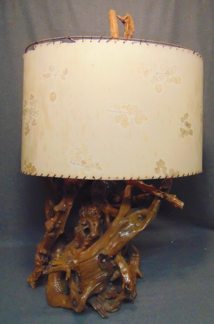 Vintage Driftwood Table Lamp: Vintage Driftwood Table Lamp. Measures 36" tall x 20" wide. Overall condition is fair with minor wear. Needs re-wireing. Shade is tattered. Starting Bid $30. Auction Estimate $30 - $40.