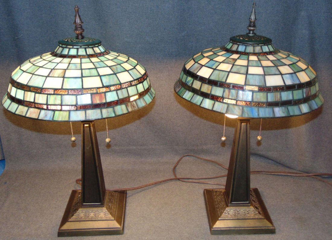 Pair (2) of Tiffany Style Stained Glass Table Lamps: Pair (2) of Tiffany Style Stained Glass Table Lamps. Each measures 26" tall x 16" wide. Condition is very good with minimal wear. No damage. Several Shipping Options Available. Starting Bid $250 for b