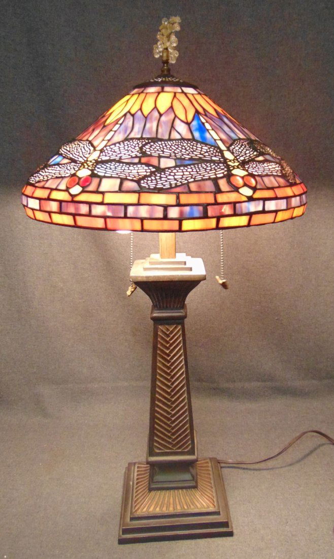 Tiffany Style Stained Glass Dragonfly Table Lamp: Tiffany Style Stained Glass Dragonfly Table Lamp. Measures 32" tall x 17" wide. Condition is very good with minimal wear. No damage. Several Shipping Options Available. Starting Bid $100. Auction Esti