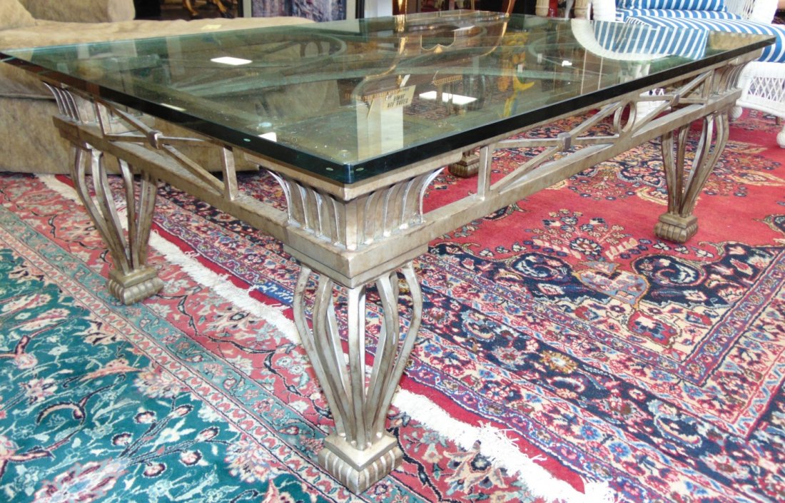 Large Wrought Iron and Glass Coffee Table: Large Wrought Iron and Glass Coffee Table. Very Heavy. Measures 21" tall x 54" wide x 38" deep. Condition is excellent to very good with minimal wear. No damage. Several Shipping Options Available. St