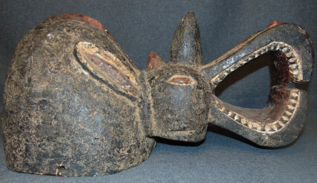 African Rhinoceros Mask C.1950: African Rhinoceros Mask Circa 1950. Authentic African Ceremonial Art. Possibly from Mambila, Nigeria or from the Baule people of Ivory Coast or Bwa people. Measures 21" x 10" wide. Overall condition i