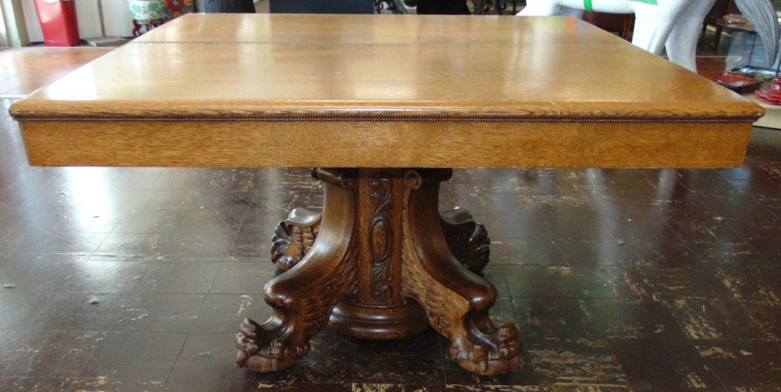 Antique Golden Oak Pedestal Dining Table: Antique Golden Oak Pedestal Dining Table. Circa 19th Century. Measures 30" tall x 50" wide x 50" deep. Includes 4 leaves. Each are 12" wide. Overall condition is very good with minor wear. No damage.