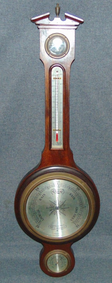 Comitti of London Banjo Barometer: Comitti of London Banjo Barometer. Sheraton style Mahogany case. Measures 28-1/2" tall x 9-1/4" wide. Overall condition is good. Wear consistent with age and use. Glass cover missing. Several Shipping