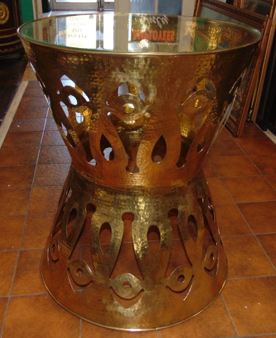 Hammered Brass Side Table: Hammered & Pierced Brass Side Table. Hourglass shape with glass top. Measures 29" tall x 23-1/2" wide. Condition is Like New. Very good. No Damage. Several Shipping Options Available. Starting Bid $10