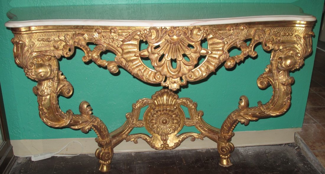 Madame Antoinette Marble Top Console Table: Madame Antoinette Marble Top Console Table. Carved and Gilt Wood with a White Marble Top. Measures 34" tall x 58-1/2" wide x 22-1/2" deep. Overall condition is Very good. No damage. Several Shipping O