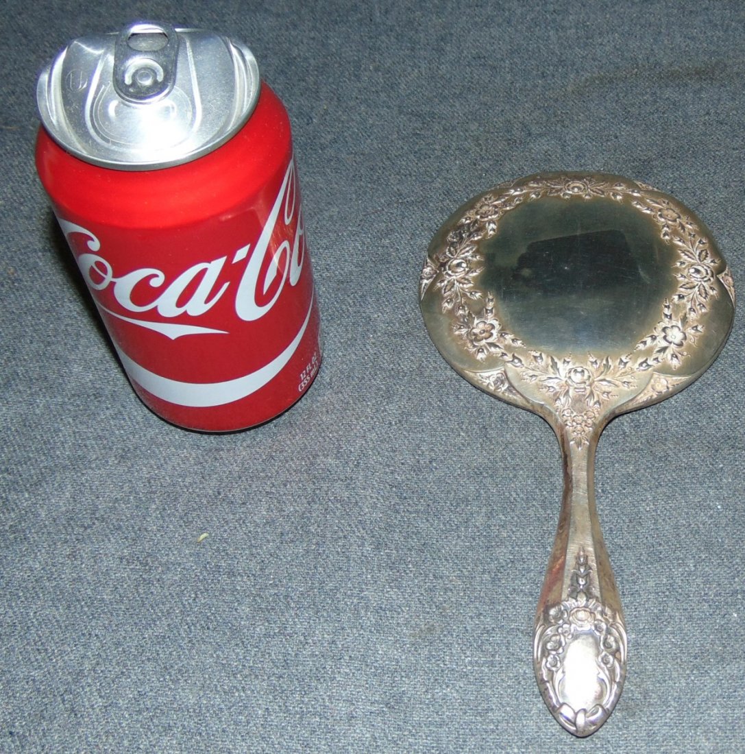 Vintage Sterling Silver Hand Mirror: Vintage Sterling Silver Hand Mirror. Marked Sterling. Measures 8-1/2" x 4-1/2". Overall condition is good to fair. Wear consistent with age and use. Small dent on side. Starting Bid $20.