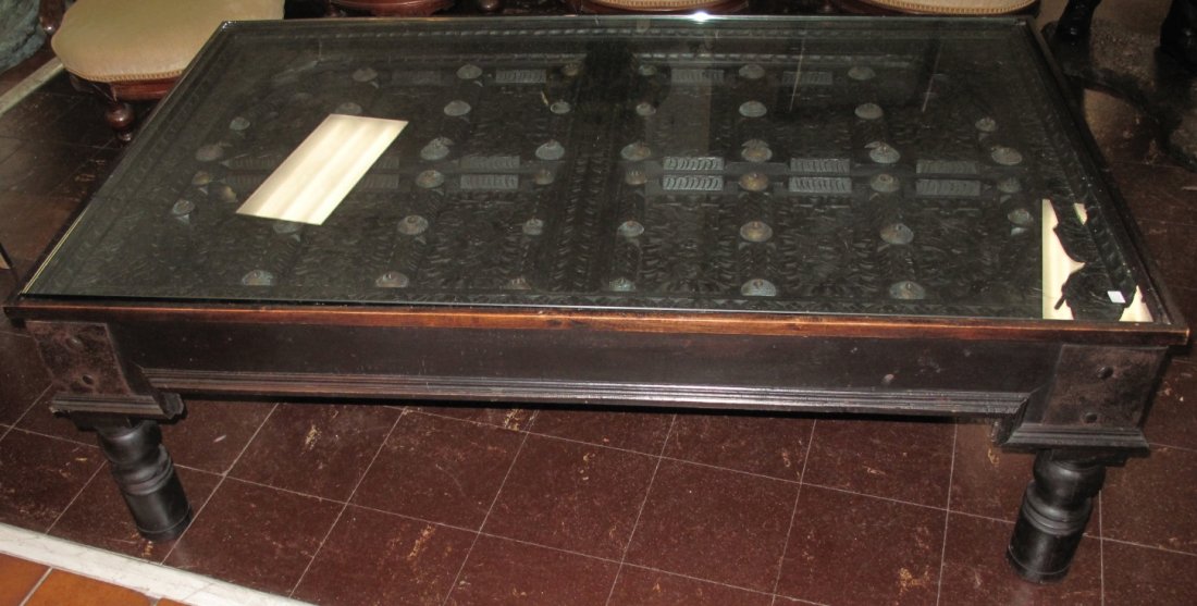 Balinese Hand Crafted Coffee Table: Balinese Hand Crafted Coffee Table with glass top. Measures 19" tall x 58" wide x 35" deep. Condition is good. Some surface wear. No damage.