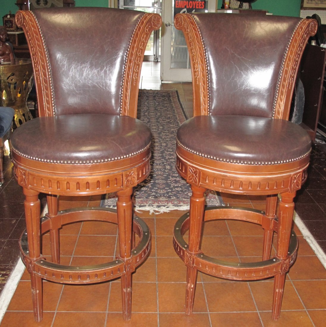 Pair (2) of Leather Swivel Bar Stools: Pair (2) of Leather Swivel Bar Stools. Solid wood frame. Each measures 45" tall x 22" wide x 26" deep. Condition is good. Some wear. Starting Bid $50 for pair.
