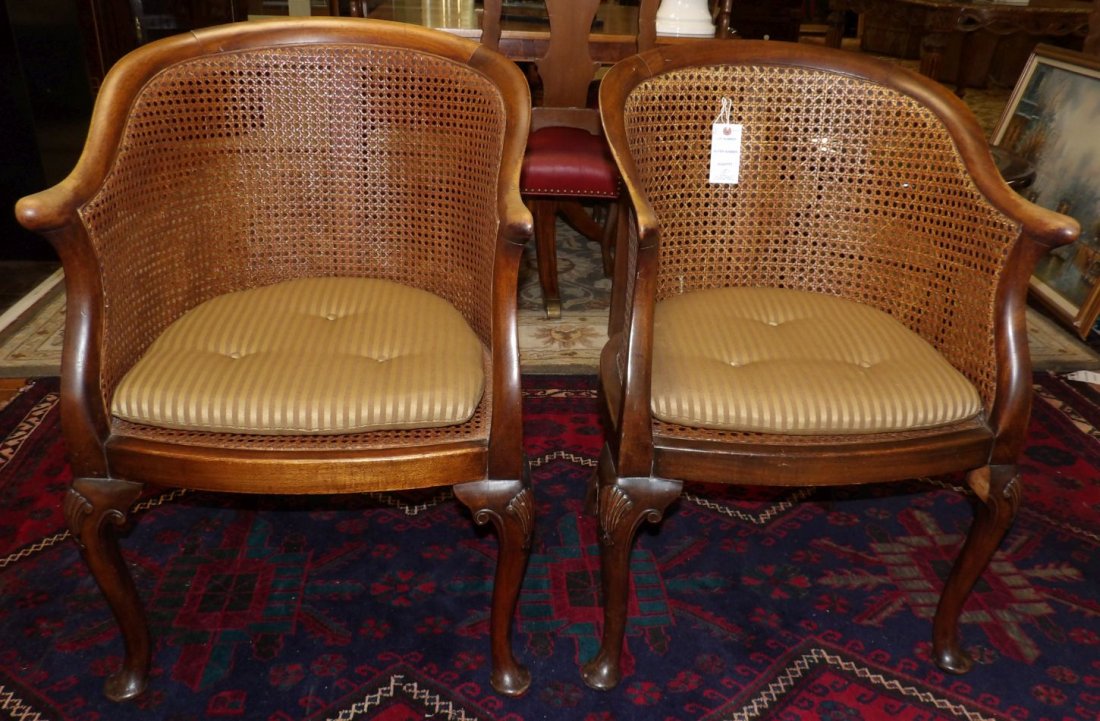 PAIR of ANTIQUE CANE BACK ARM CHAIRS: Pair of Antique Cane Back Arm Chairs. Each measures 34" tall x 22" wide x 21" deep. Overall condition is good. Some wear to finish. Starting Bid $50. Auction Estimate $250 - $350.