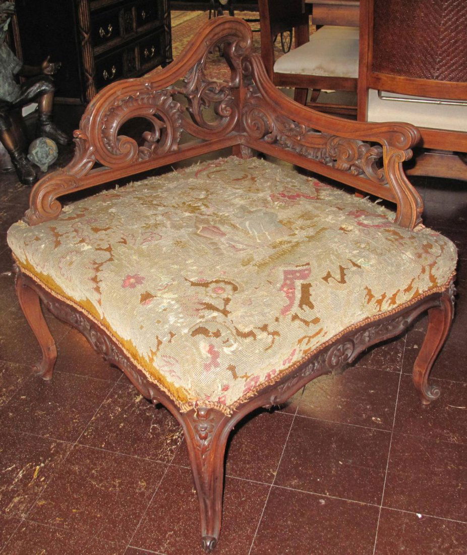 ANTIQUE WALNUT CORNER CHAIR NEEDLEPOINT: Unusual, Antique Carved Walnut Corner Chair with Needlepoint Upholstered Seat. Measures 32-1/2" tall x 29" wide x 29" deep. Condition is good to fair. Some Wear. Starting Bid $80. Auction Estimate $25