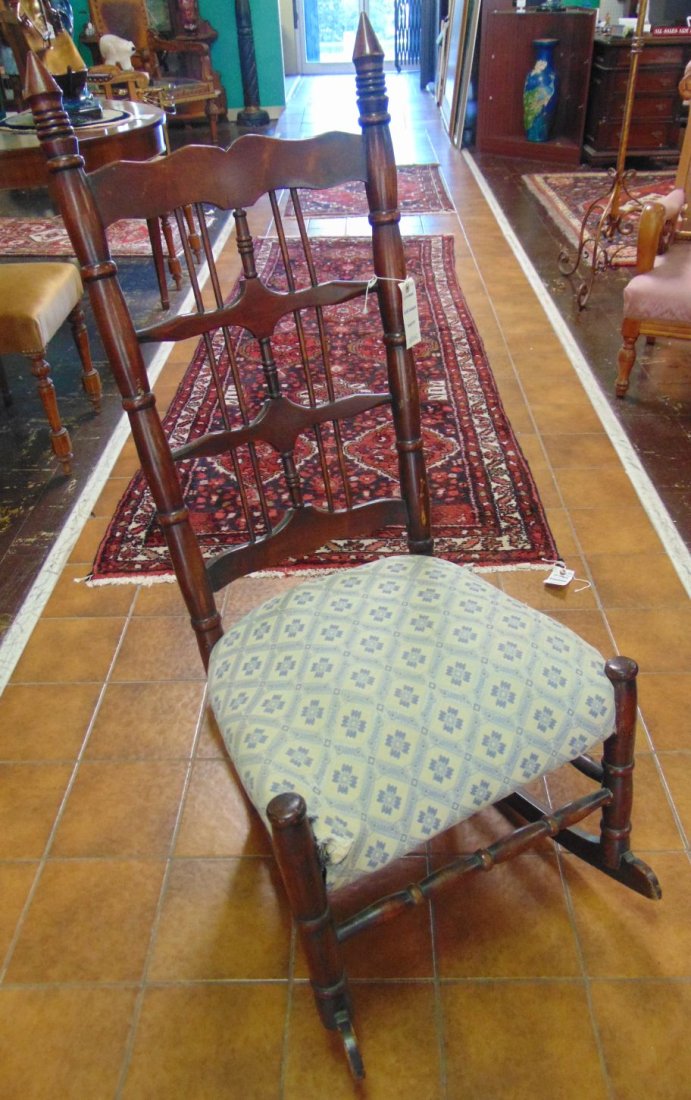 ANTIQUE LADDERBACK ROCKING CHAIR: Antique Ladderback Style Rocking Chair. Stands 44" tall x 20" wide. Condition is good to fair. Starting Bid $10. Auction Estimate $50 - $80.