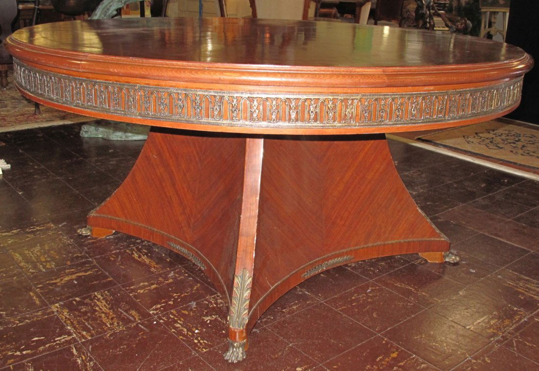 FRENCH EMPIRE STYLE ROUND DINING TABLE: French Empire Style Round Dining Table with Pedestal Base. Measures 31" tall x 65" wide. Condition is good. No damage. Starting Bid $200. Auction Estimate $750 - $1,200.