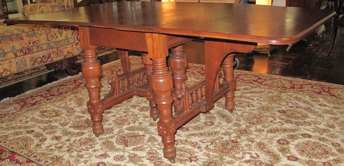 ANTIQUE EASTLAKE WALNUT DROP LEAF DINING TABLE: Antique Eastlake Walnut Drop Leaf Dining Table. Measures 29-1/2" tall x 70" wide, when opened and 40" deep. Measures 27" wide with leaves down. Condition is good. No damage. Starting Bid $80. Auction