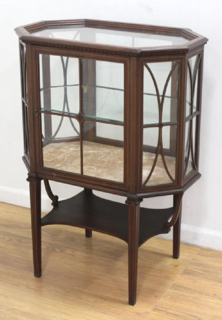 Edwardian Style Mahogany Octagonal Shaped Curio: With pencil inlays. With 1 glass shelf. Approx. 38 1/2" H x 27 1/2" W x 17 1/2" D. (6029)