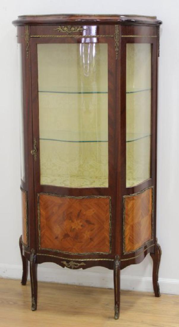 French Serpentine Front Curio Cabinet: With floral inlays. Bronze mounts. Approx. 59 1/2" H x 32" W x 14" D.