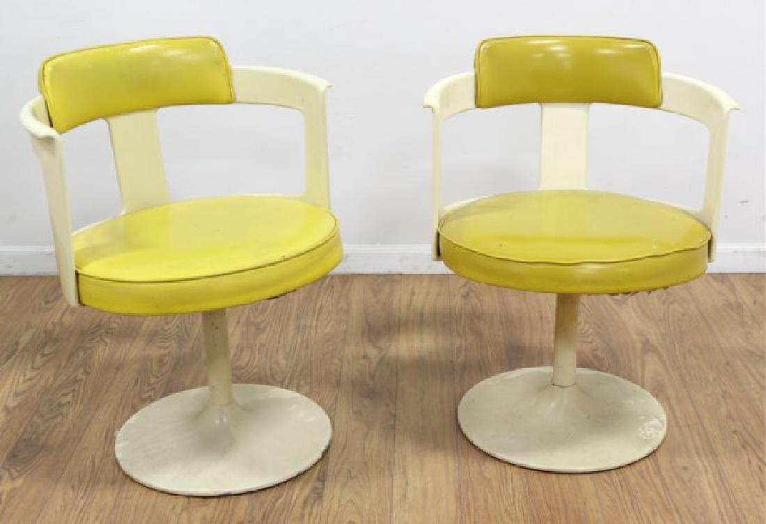 Pair 70s American Fiberglass Swivel Armchairs: Upholstered in yellow leatherette.