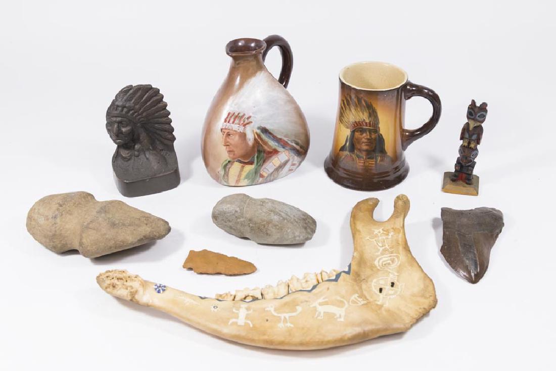 Lot 9 Indian-Related Artifacts: Ax heads, jaw bone, single bookend, mug, jug, two totems, arrowhead, and shark tooth. Tallest approx. 6 1/4" H, arrowhead 3" L.