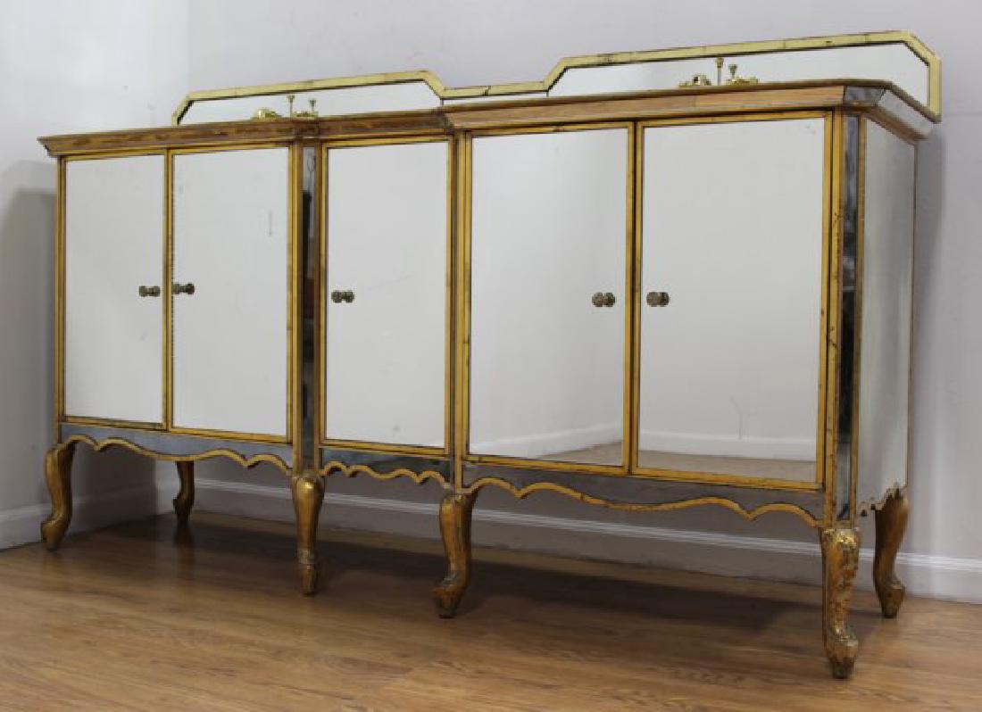 Rococo Style Parcel Gilt Mirrored Cabinet: Fitted with 2 sinks. Approx. 42 1/4" H x 71 1/2" W x 20" D. Property from the Erno Laszlo Institute, West Broadway, NYC. (6191) Some mirror moldings missing. Gilding chipped throughout.